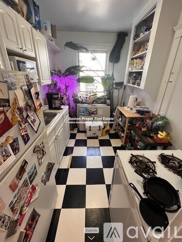 A kitchen with a black and white checkered floor.