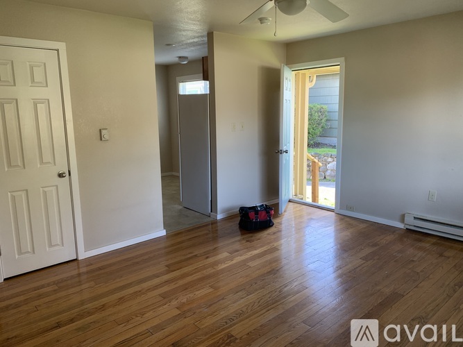A room with wooden floors and a ceiling fan.