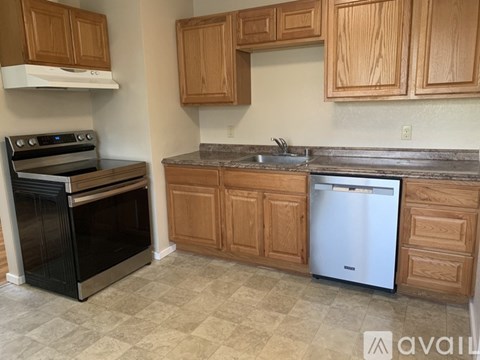 A kitchen with wooden cabinets and a black oven.
