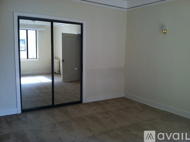 A room with a sliding glass door leading to a balcony.