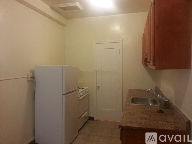 A bathroom with a sink, mirror, and tiled walls.