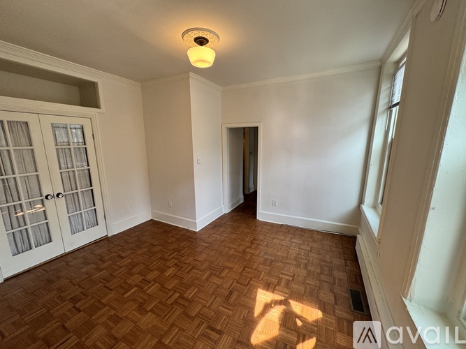 A room with a wooden floor and white walls.
