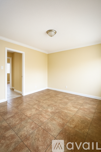 A room with wooden flooring and a window.