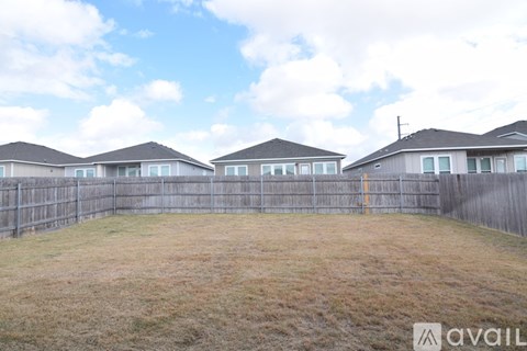 A row of houses with a fence in front of them.