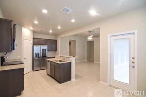 A kitchen with brown cabinets and a white island.