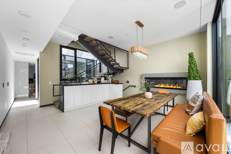 A modern kitchen with a dining table and chairs.