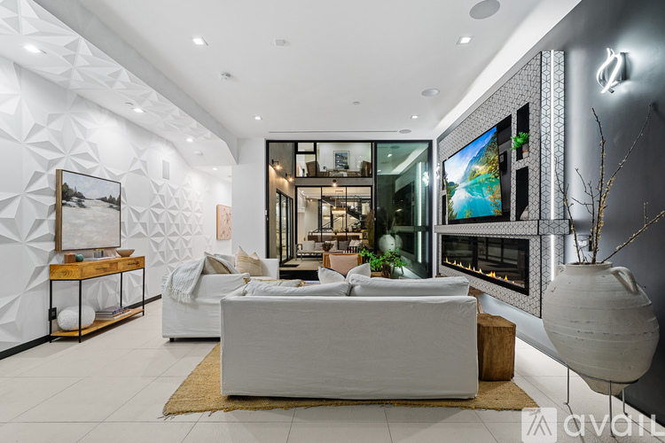 A bedroom with a large bed and a balcony with glass doors.