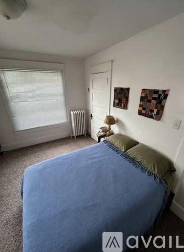 A living room with a yellow couch and a white door.