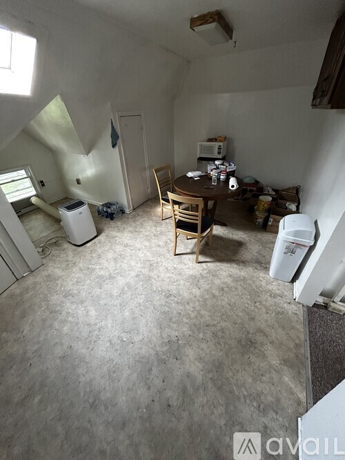 A room with a table and chairs in it.