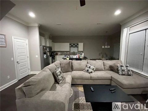 A living room with a grey couch and a black coffee table.