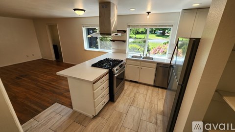 A kitchen with a white countertop and a black stove top oven.