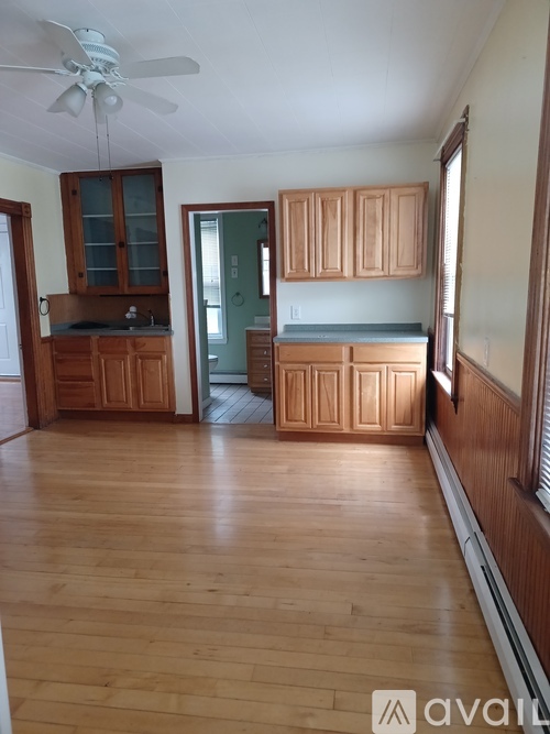 A room with wooden floors and cabinets.