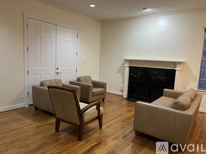 A bedroom with a bed, nightstand, and chair.