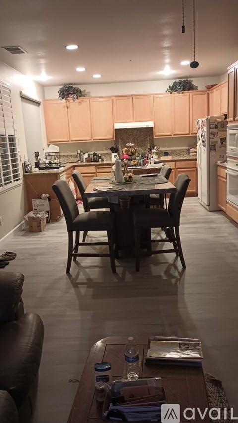 A kitchen with a table and chairs in the middle of the room.