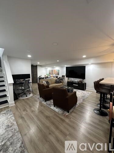 A living room with a brown couch and a television.