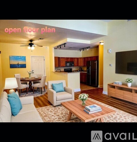 A living room with a dining table and chairs, a sofa, a coffee table, and a painting on the wall.