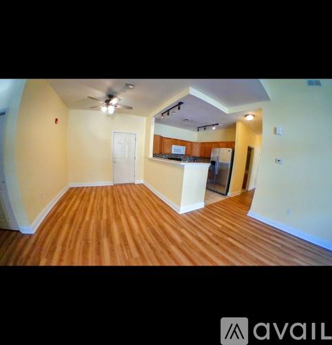 A room with wooden floors and a ceiling fan.