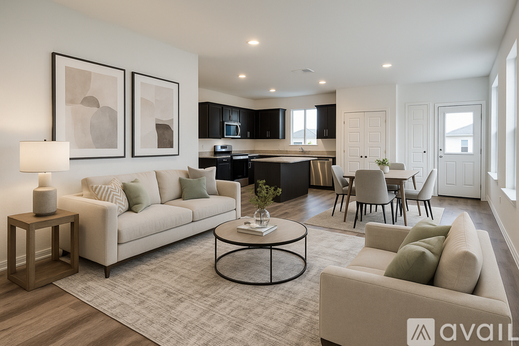 A spacious room with wooden flooring and white walls.