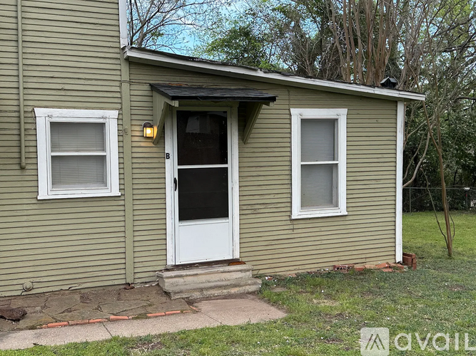 A small house with a white door and two windows.