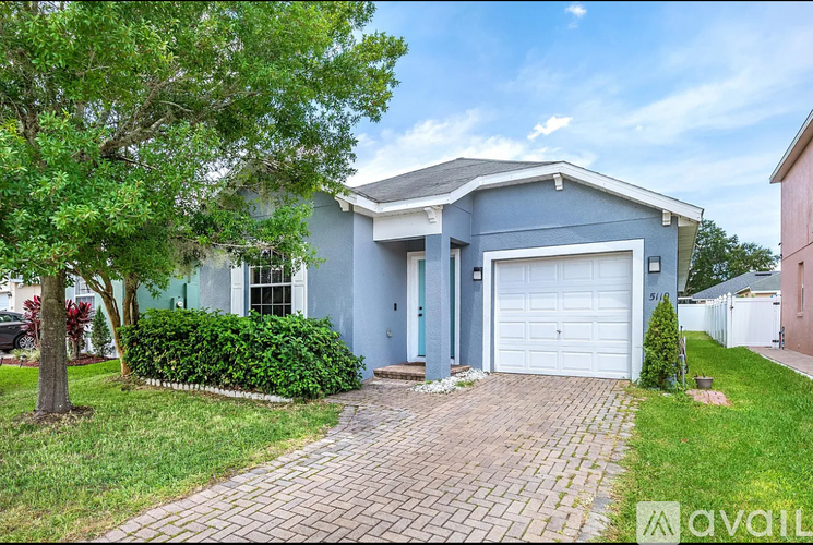 A house with a blue exterior and a white garage door.