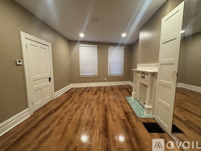 A room with wooden floors and white doors.