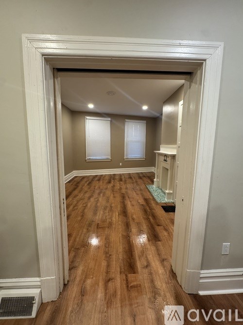 A room with wooden floors and white walls.