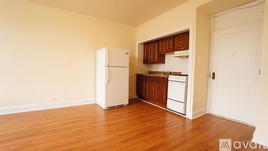 A kitchen area with a black refrigerator, microwave, and oven.