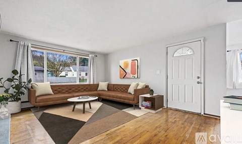 A living room with a brown sofa and a coffee table.