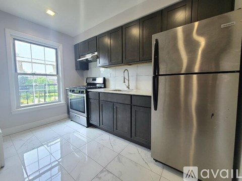 A kitchen with a stainless steel refrigerator, microwave, oven, and dishwasher.