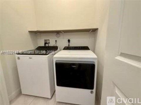 A white dishwasher and a white oven in a kitchen.