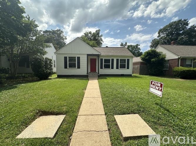 A house with a red door is for rent.