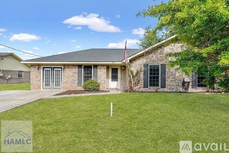 A house with a flag on the roof and a sign that says "available".
