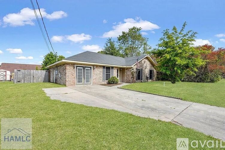 A house with a driveway in front of it is for sale.