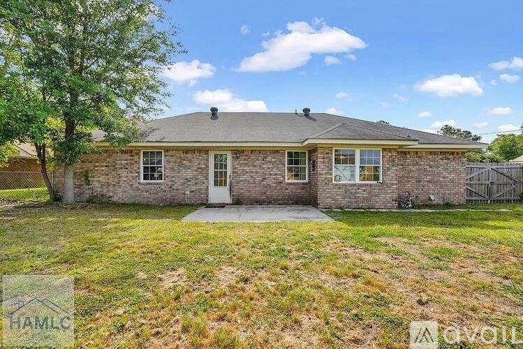 A house with a front yard and a tree is for sale.