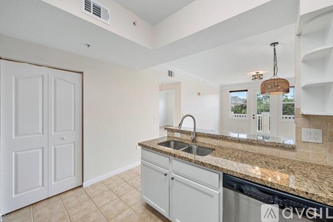 A kitchen with a sink and a counter.