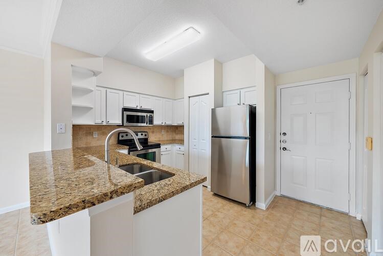 A kitchen with granite countertops and stainless steel appliances.