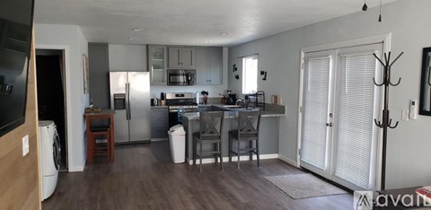 A kitchen with a table and chairs in the middle of the room.