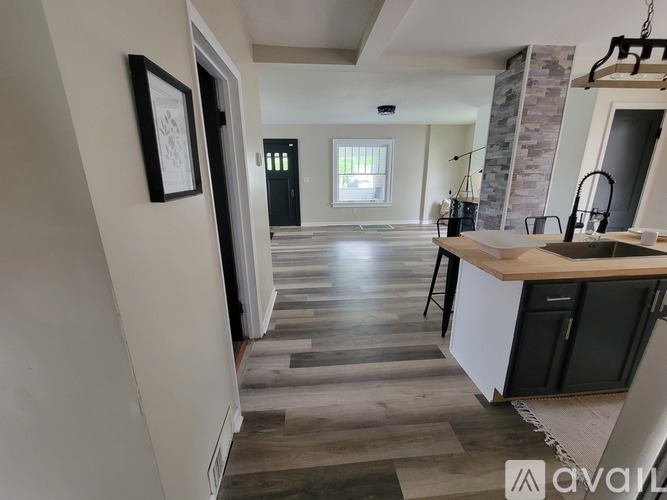 A kitchen with a wooden floor and a white counter.