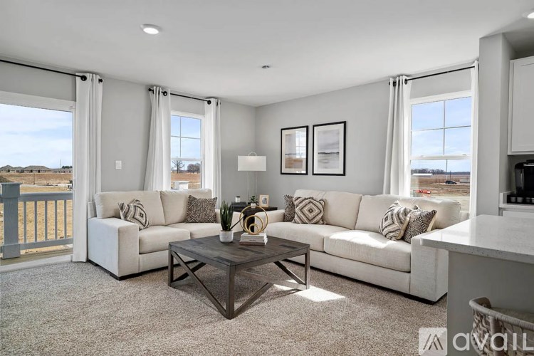 A living room with a white couch and a coffee table.