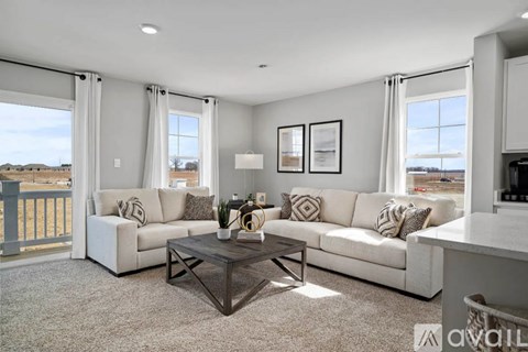 A living room with a white couch and a coffee table.