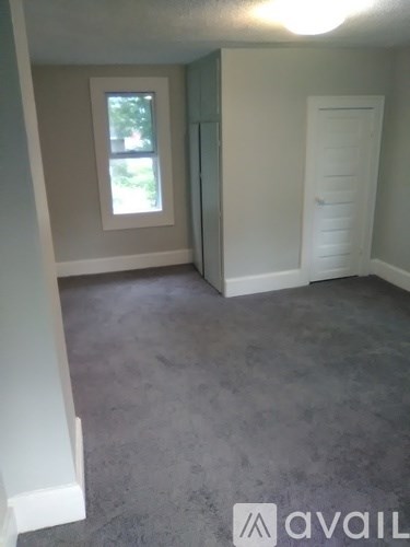A room with a window and a door.