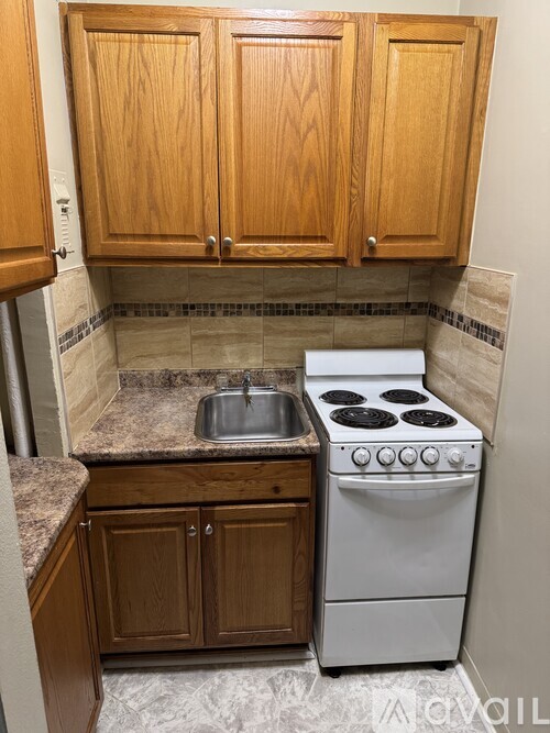 A kitchen with a white oven and sink.