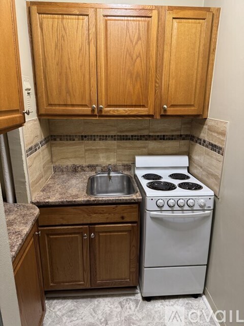 A kitchen with a white oven and sink.