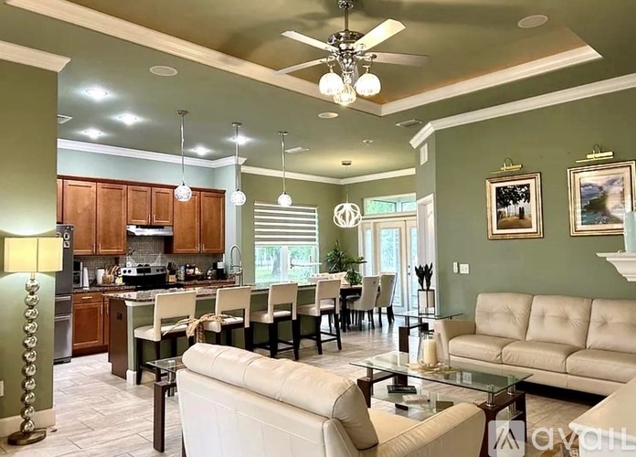 A kitchen with a dining table and chairs.