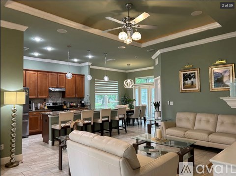 A spacious kitchen and living room with a glass table and chairs.