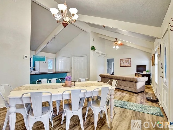 A dining room with a table and chairs.