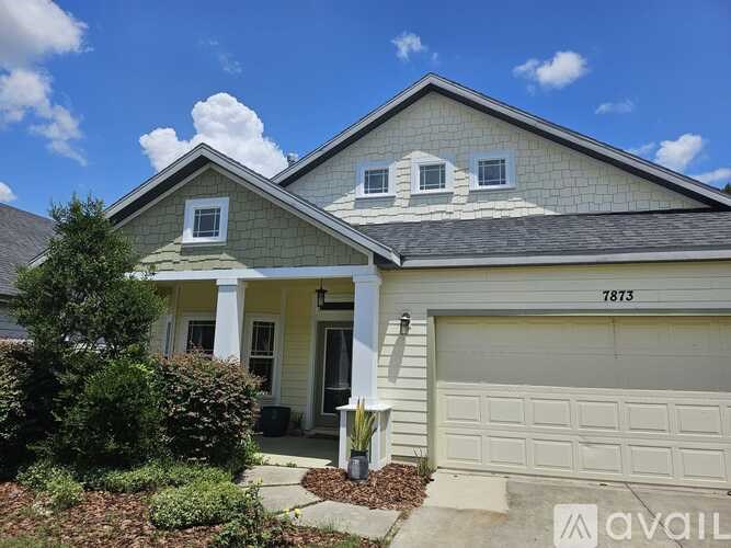 A house with the number 7873 on the garage door.