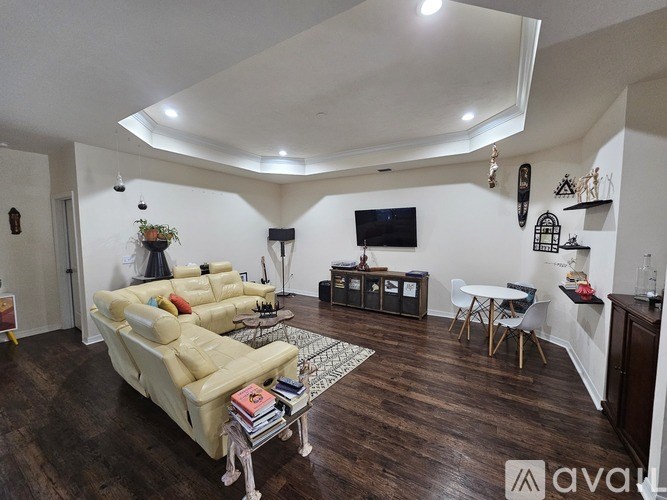 A living room with a white sofa and a television.