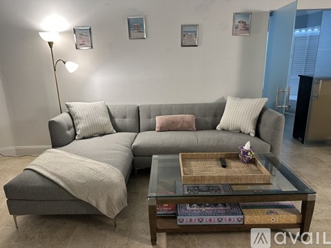 A living room with a glass table and chairs.