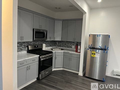 A kitchen with a refrigerator on the right side.